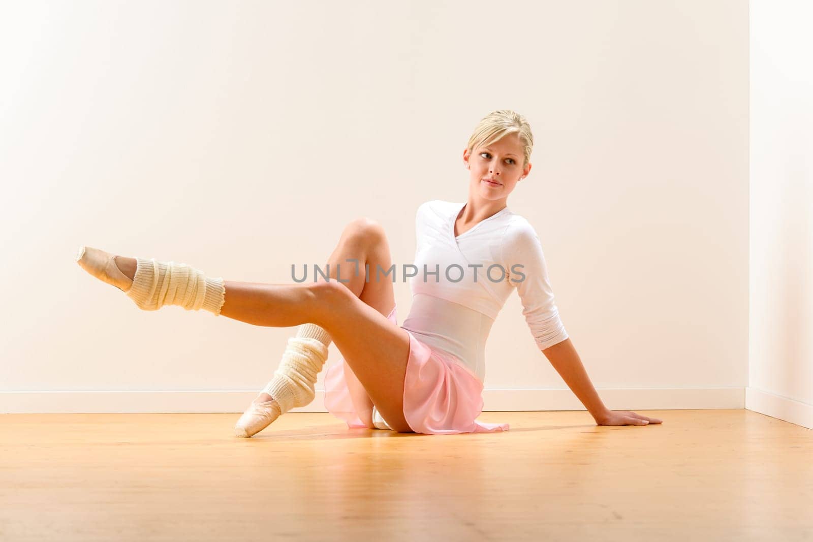Young beautiful ballerina exercising in the studio woman ballet dancer