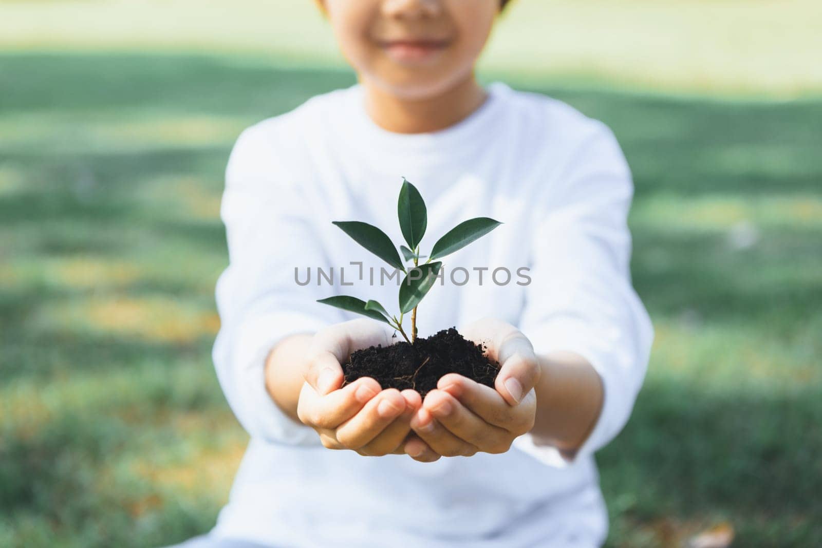 Little boy holding plant to promote eco lifestyle. Gyre by biancoblue