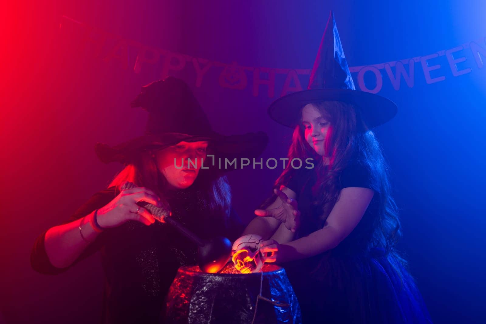 Funny child girl and woman in witches costumes for Halloween. by Satura86