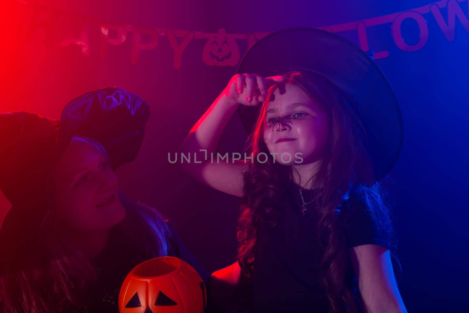 Funny child girl and woman in witches costumes for Halloween with pumpkin Jack. by Satura86