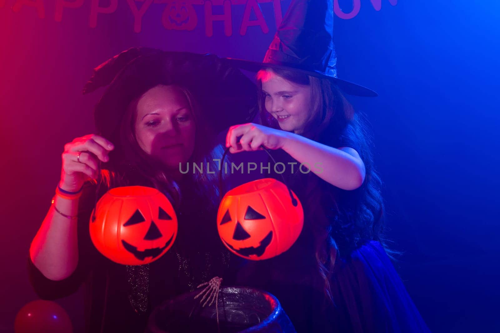 Funny child girl and woman in witches costumes for Halloween. by Satura86