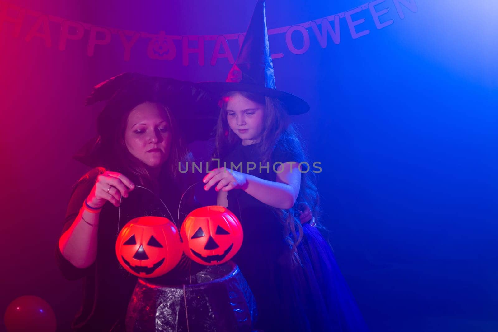Funny child girl and woman in witches costumes for Halloween with pumpkin Jack by Satura86