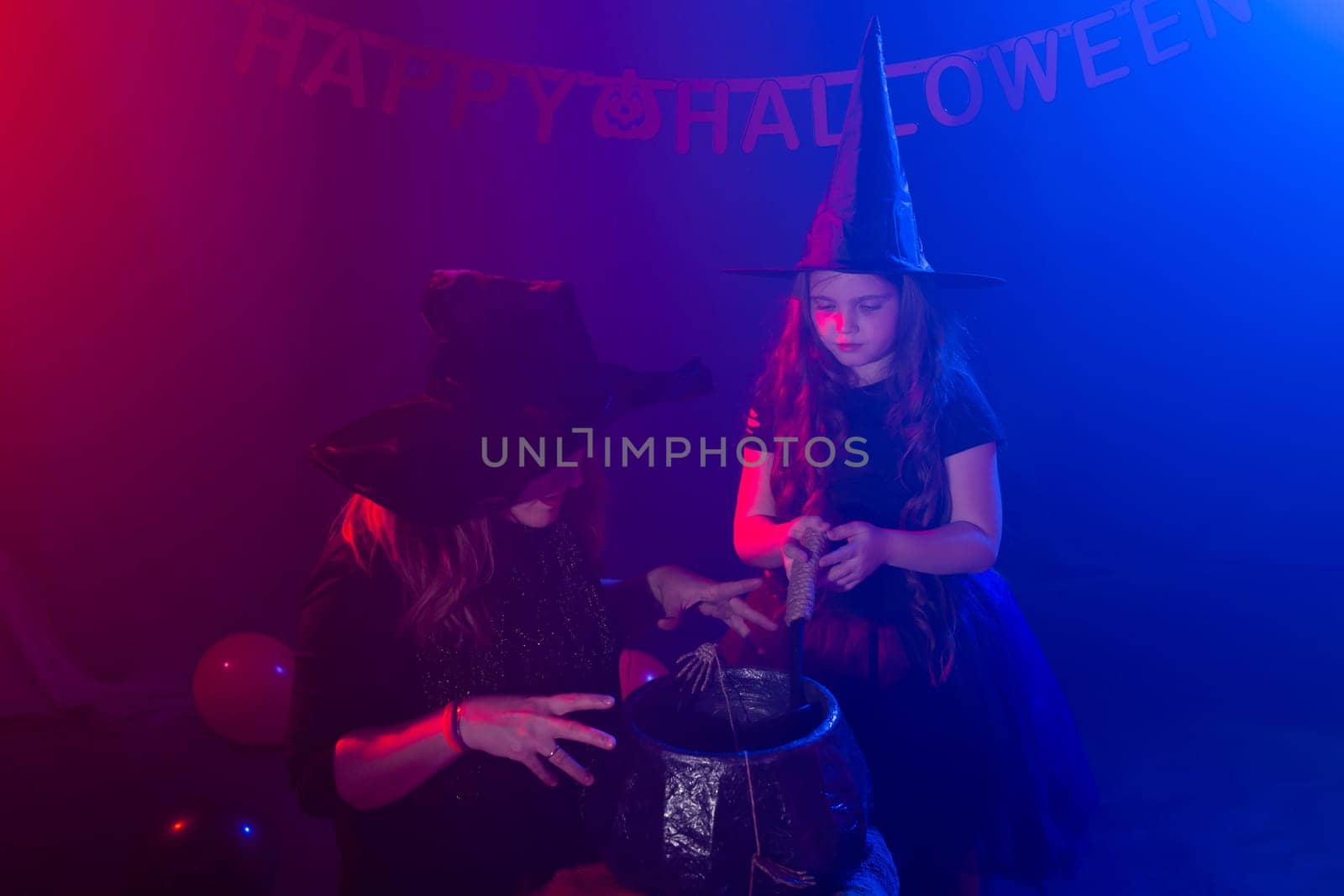 Funny child girl and woman in witches costumes for Halloween with pumpkin Jack by Satura86