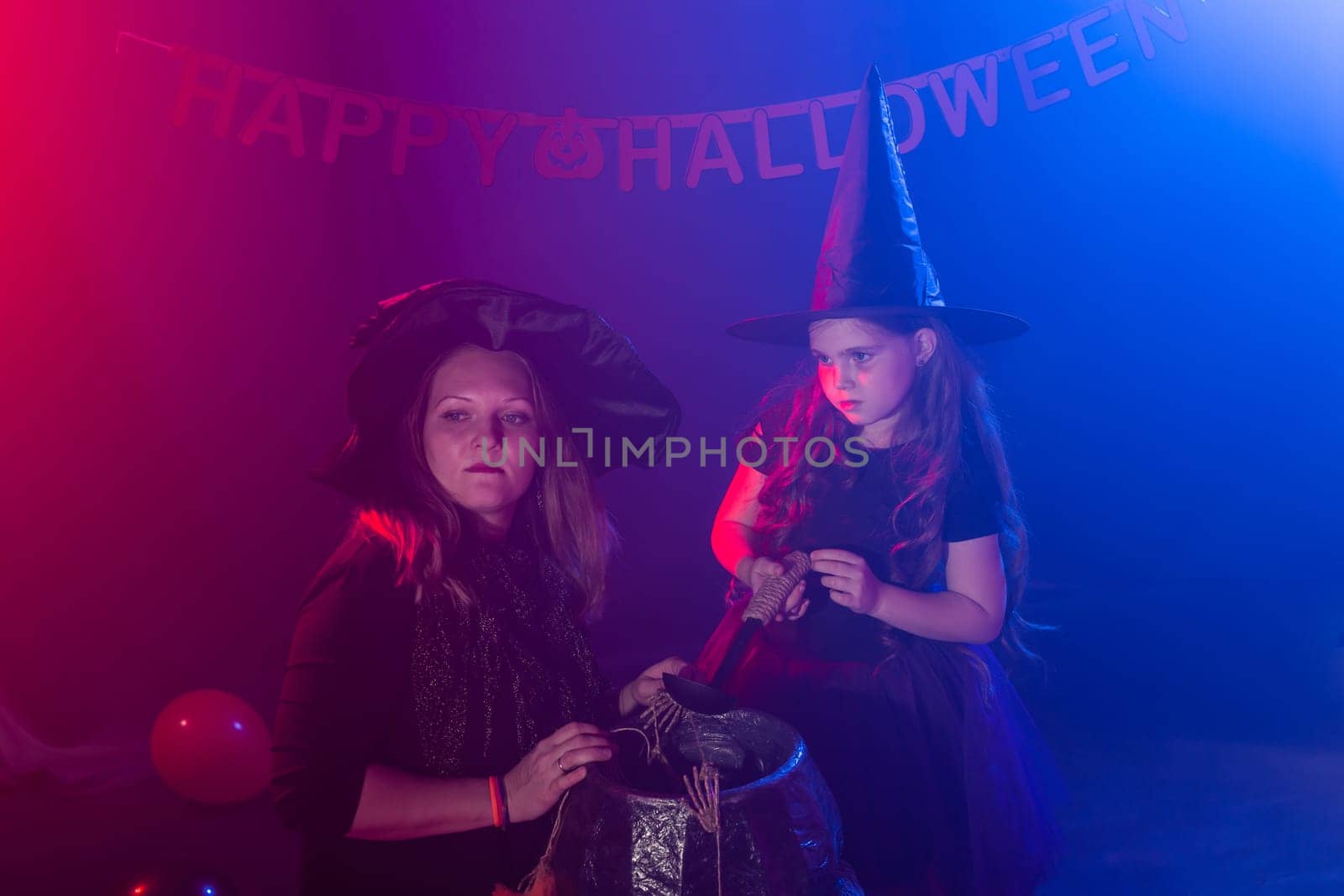 Funny child girl and woman in witches costumes for Halloween with pumpkin Jack. by Satura86