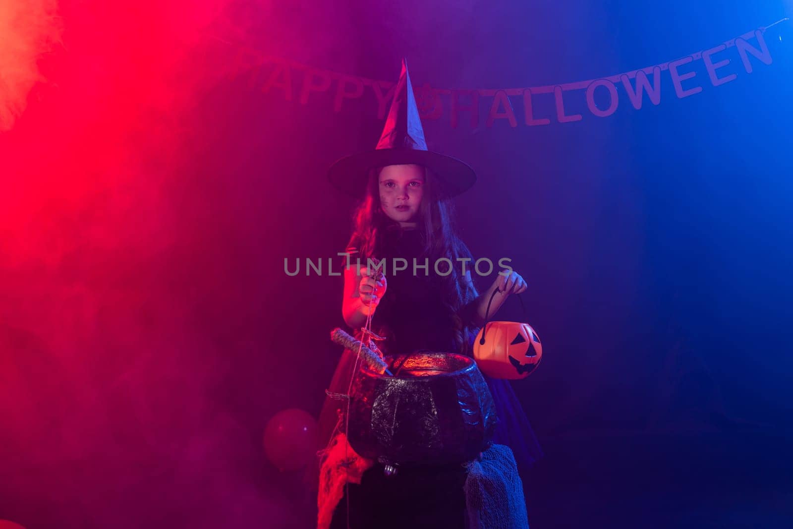 Little witch child cooking potion in the cauldron on Halloween. by Satura86