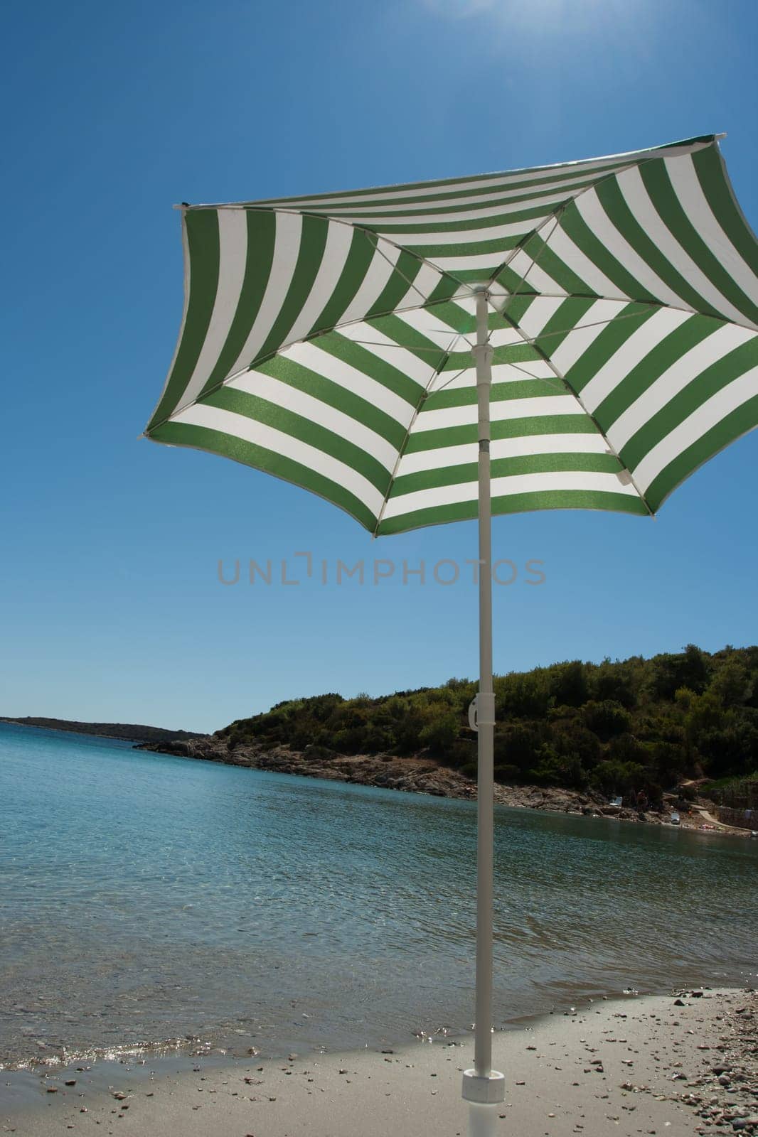 Parasol on the sand beach (Vis, Croatia)