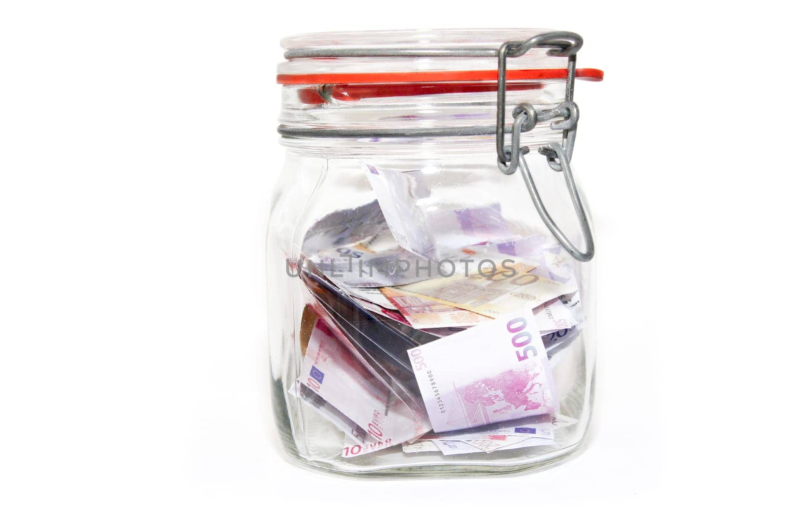 Banknotes in mason jar against white background