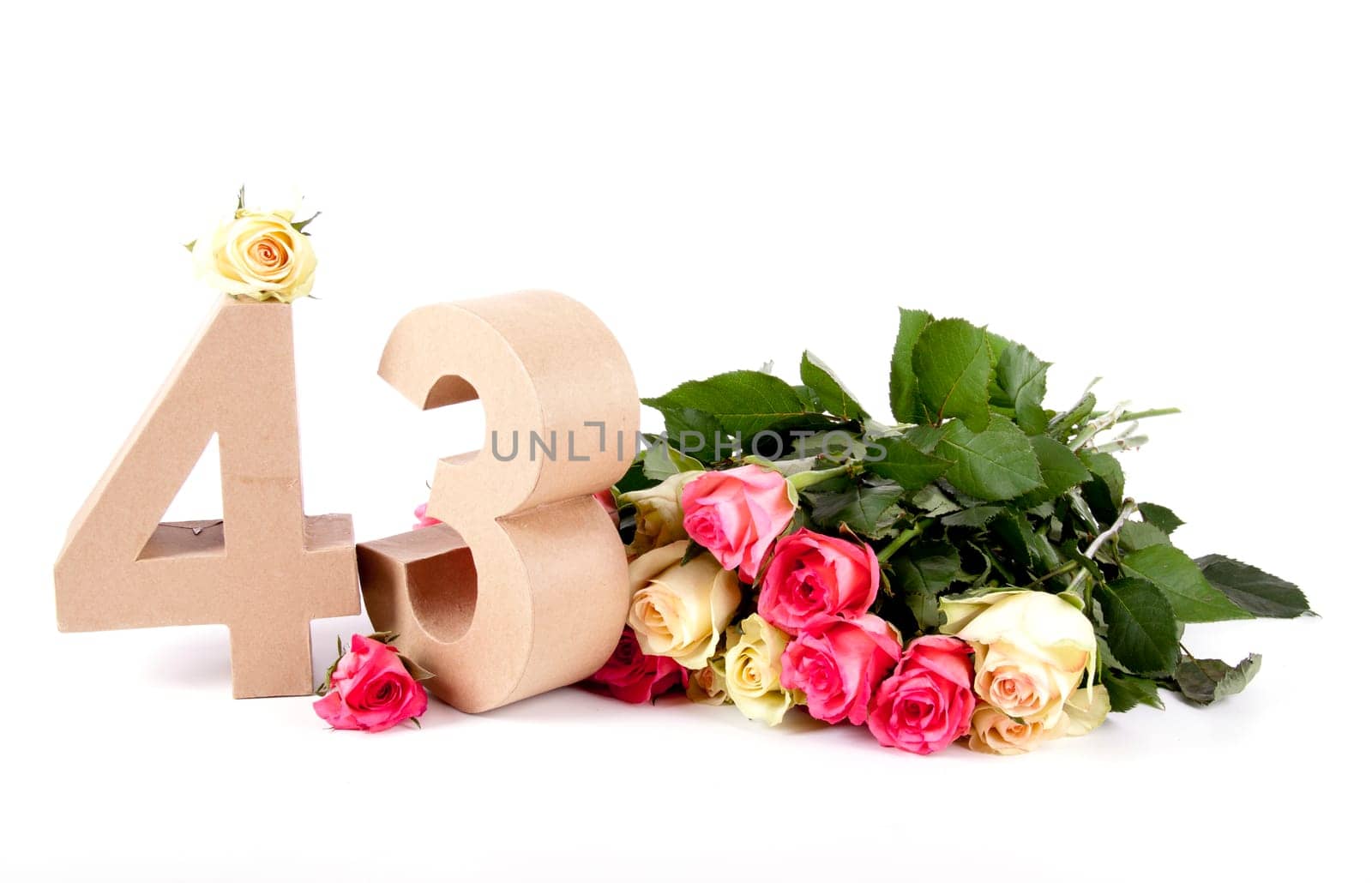 Number of age in a colorful studiosetting,surrounded with roses