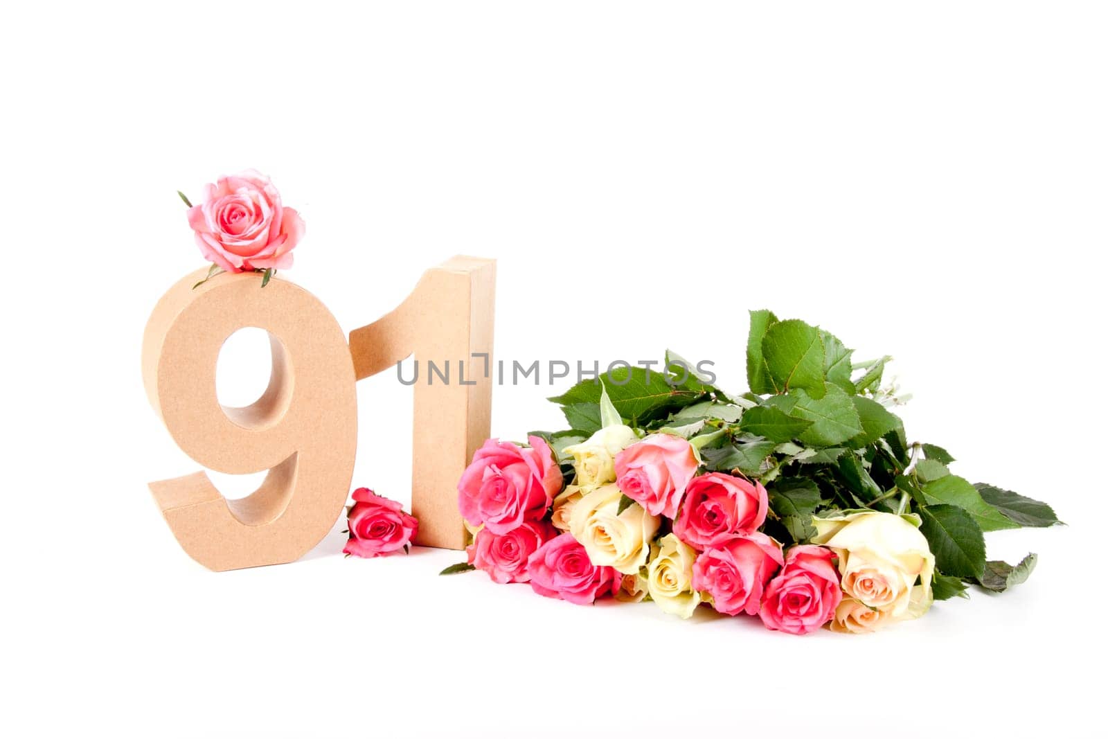 Number of age in a colorful studiosetting,surrounded with roses