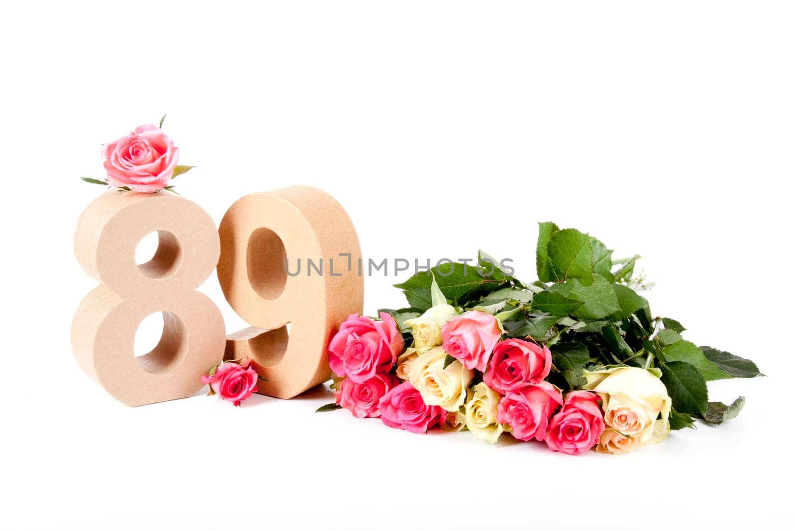 Number of age in a colorful studiosetting,surrounded with roses