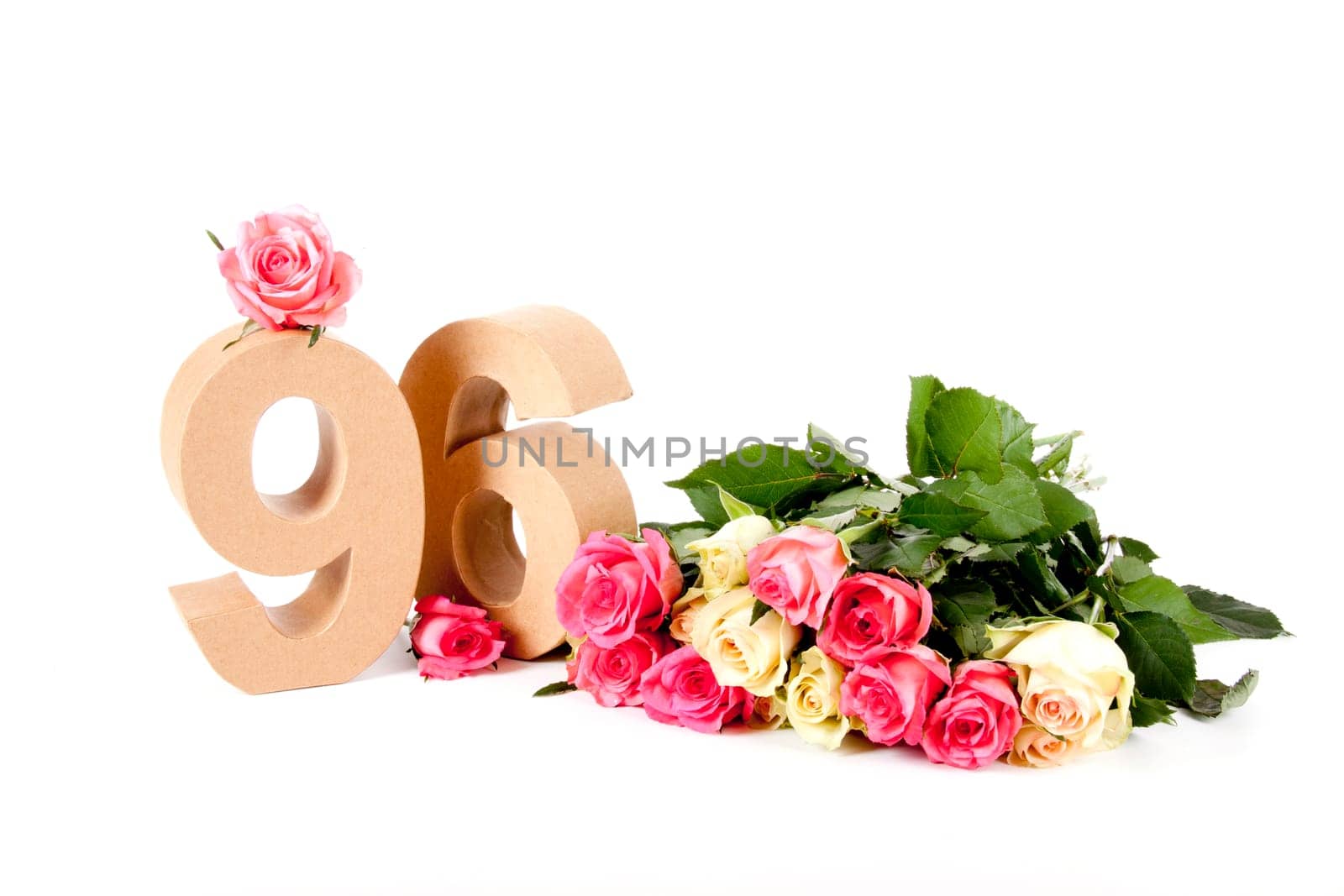 Number of age in a colorful studiosetting,surrounded with roses