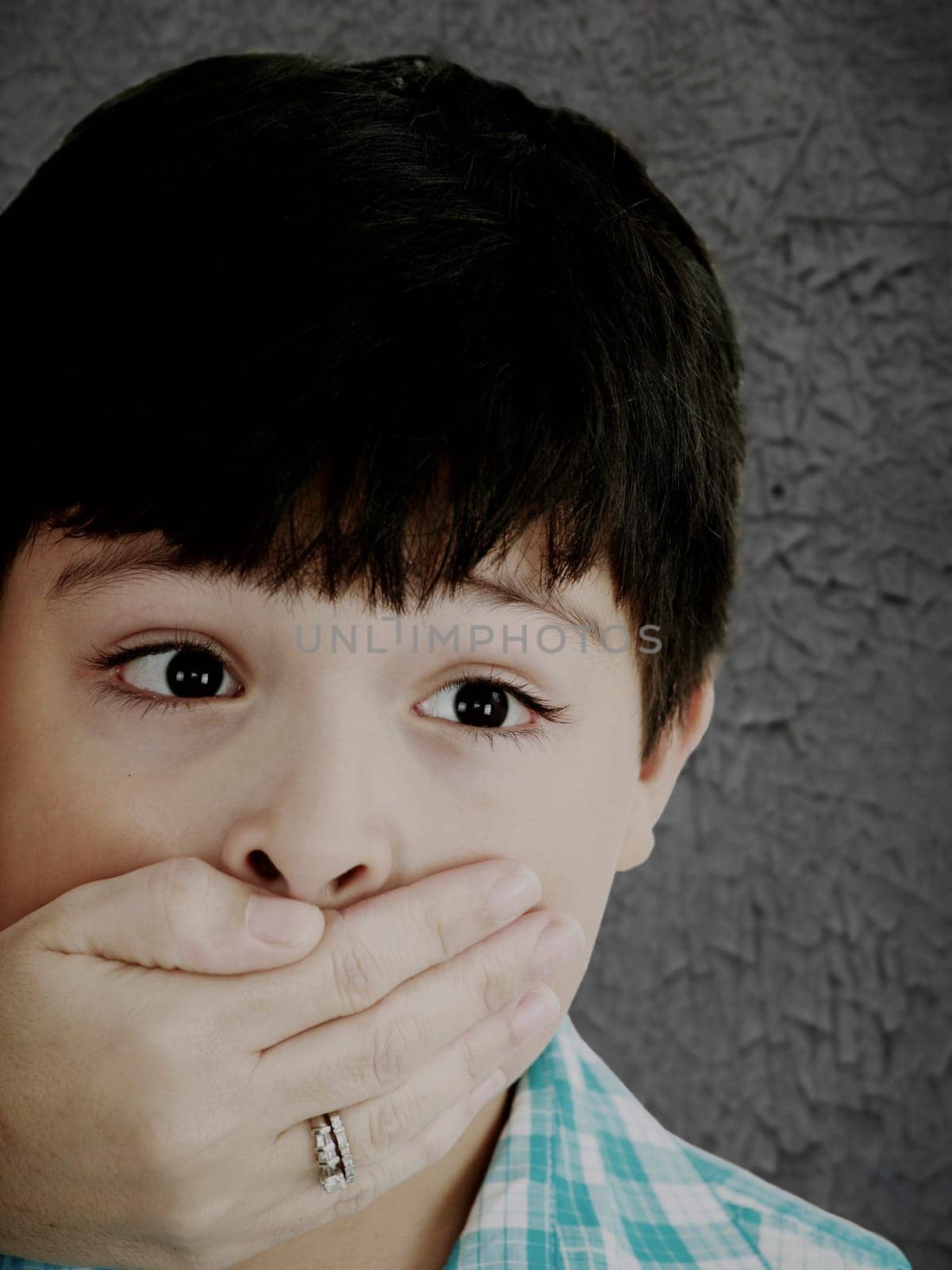 Scared 8 year old boy being abused or abducted by adult female.