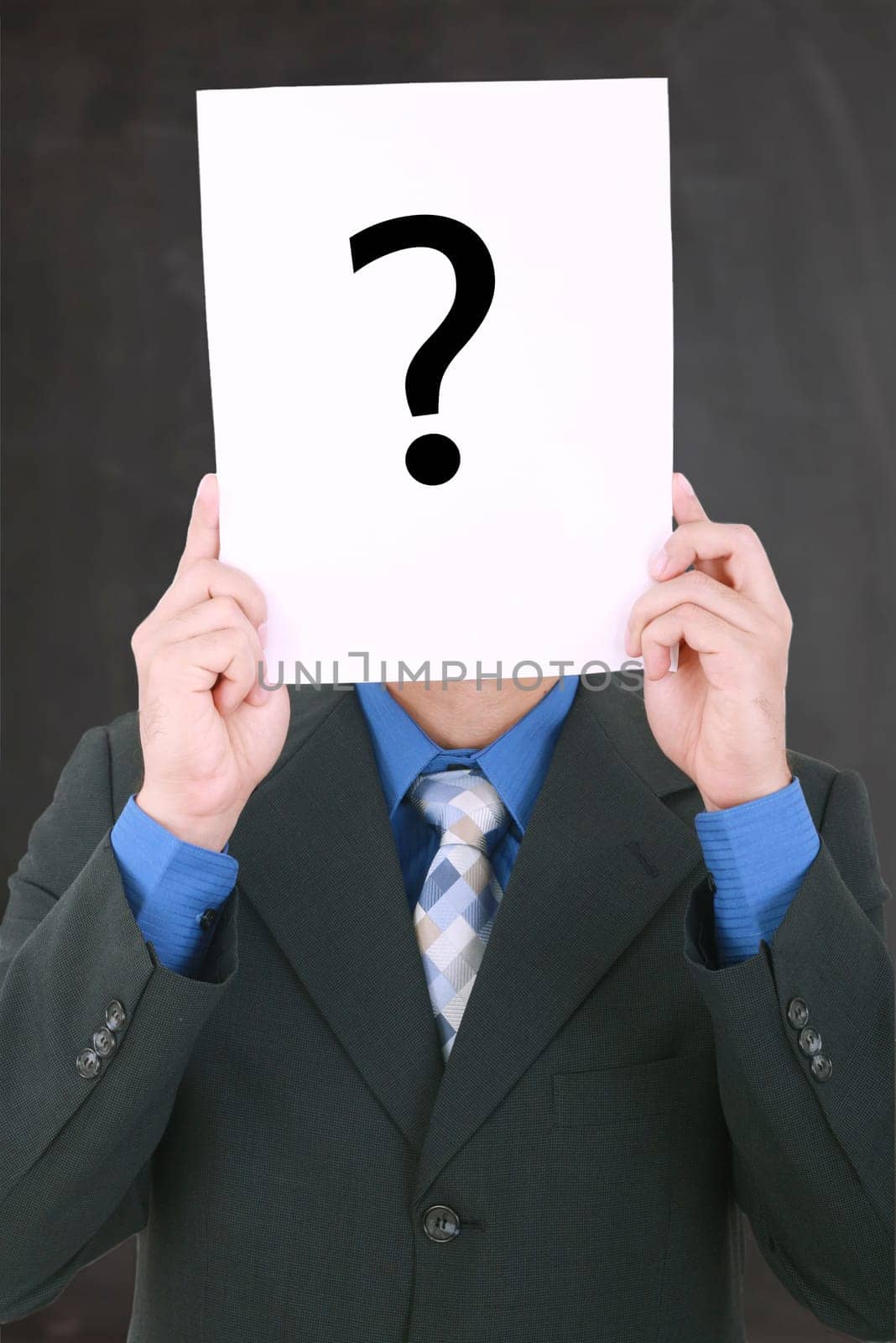 Young businessman holding a white billboard with a question mark on it