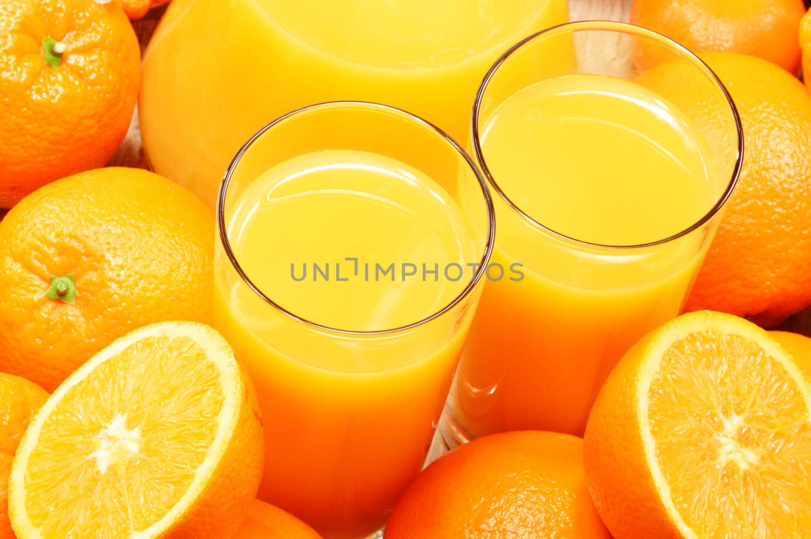 Composition with two glasses of orange juice and fruits