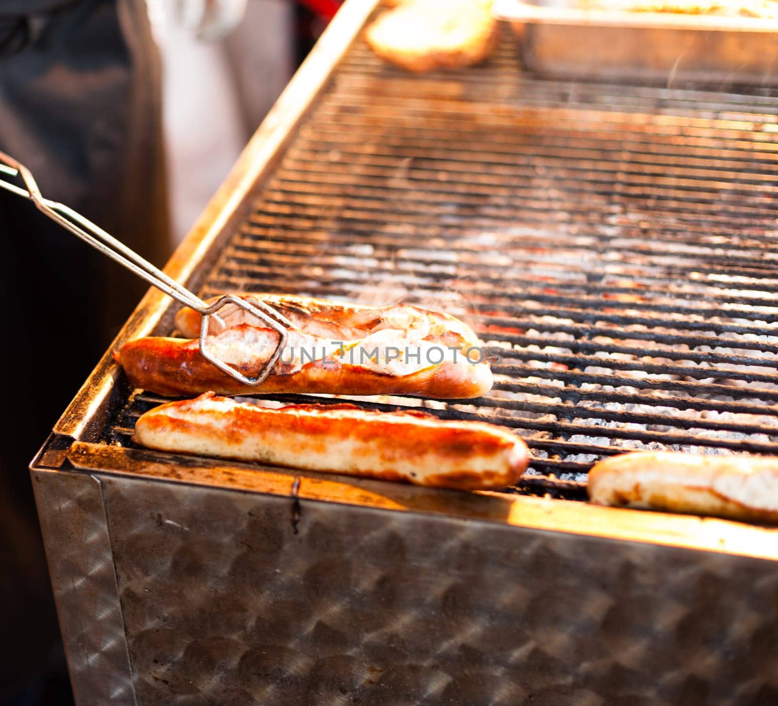 German sausages being grilled over coal outdoors