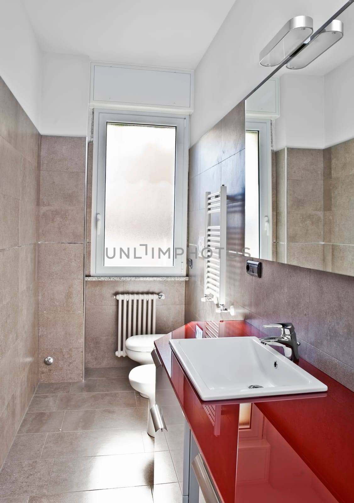 Red bathroom with toilette, bidet, heater, lavabo and mirror in soft hdr