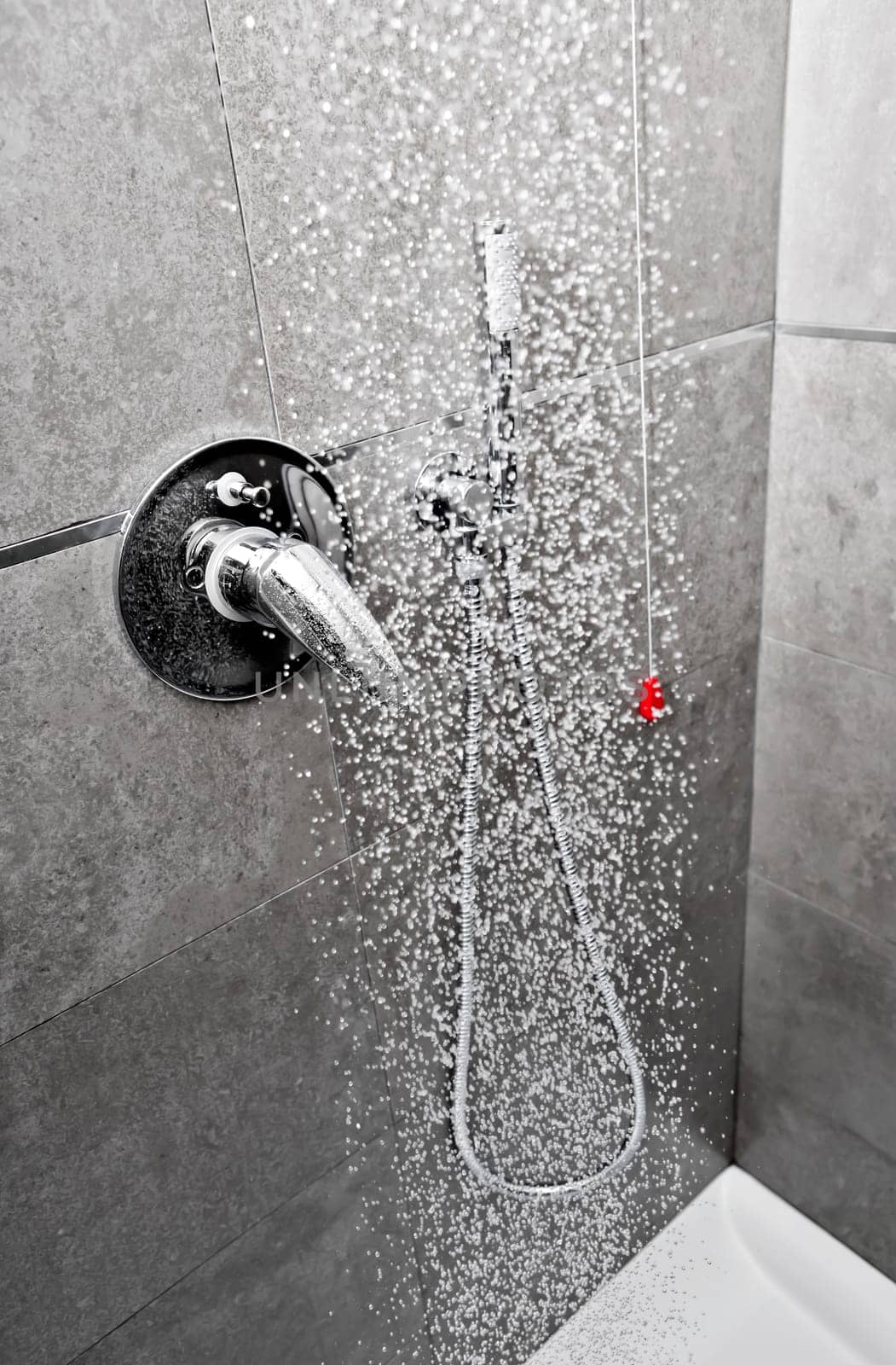 Shower handle with water falling on the flloor