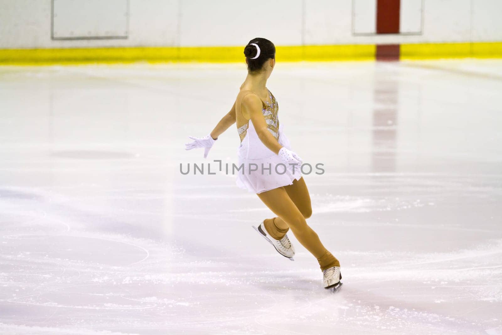 woman figure skater performing  on ice