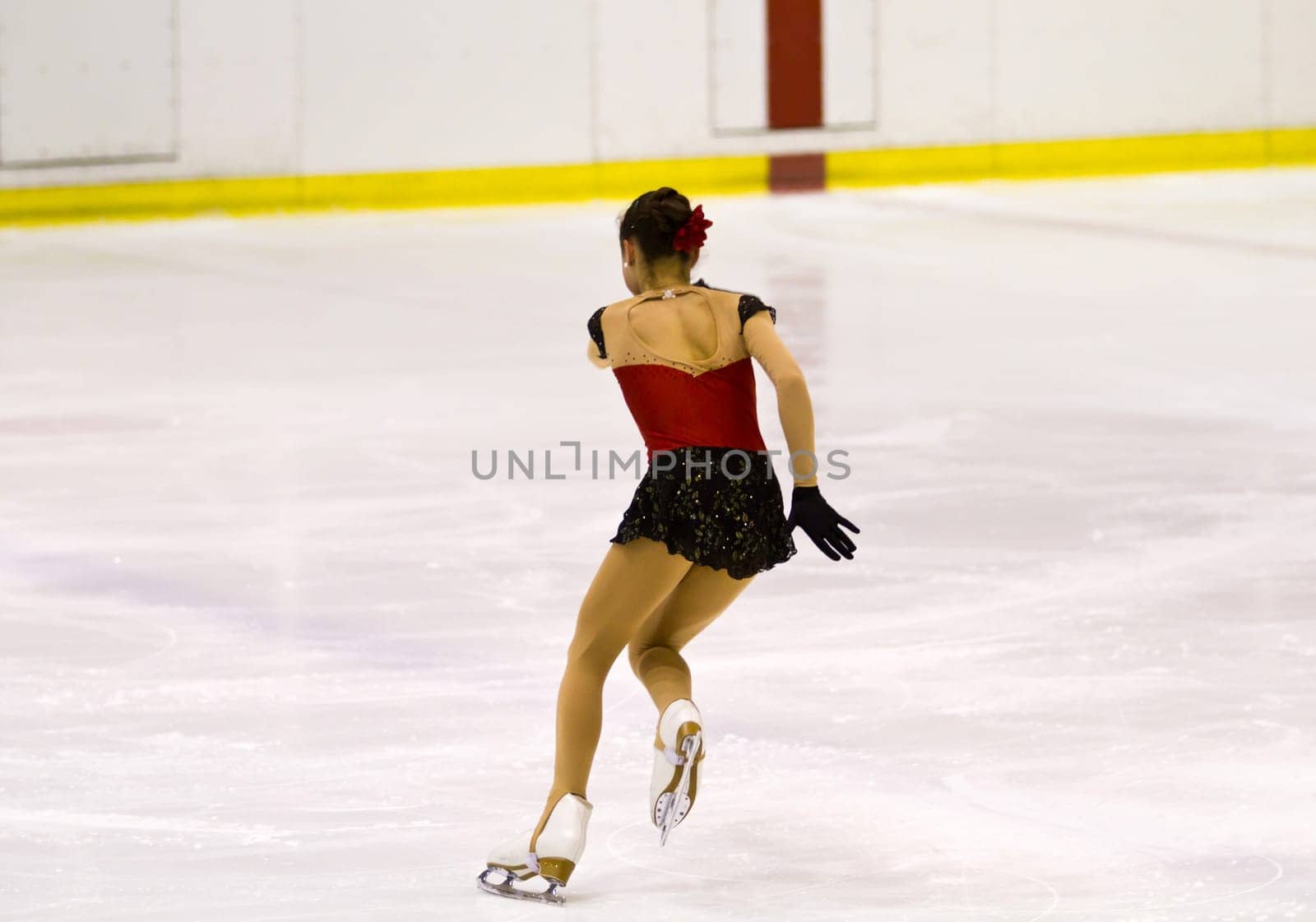woman figure skater performing  on ice