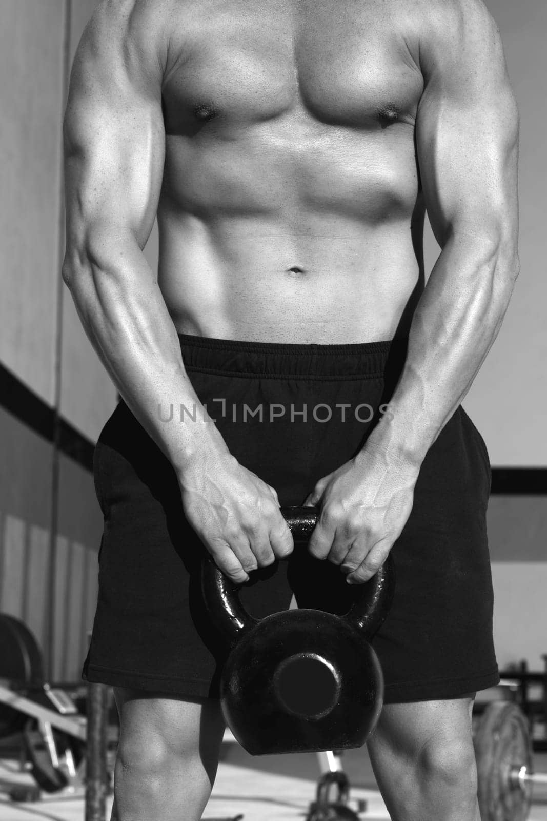 Crossfit Kettlebells swing exercise man workout at fitness gym
