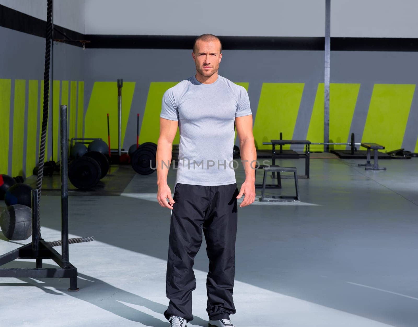 Fitness man at gym standing with crossfit stuff