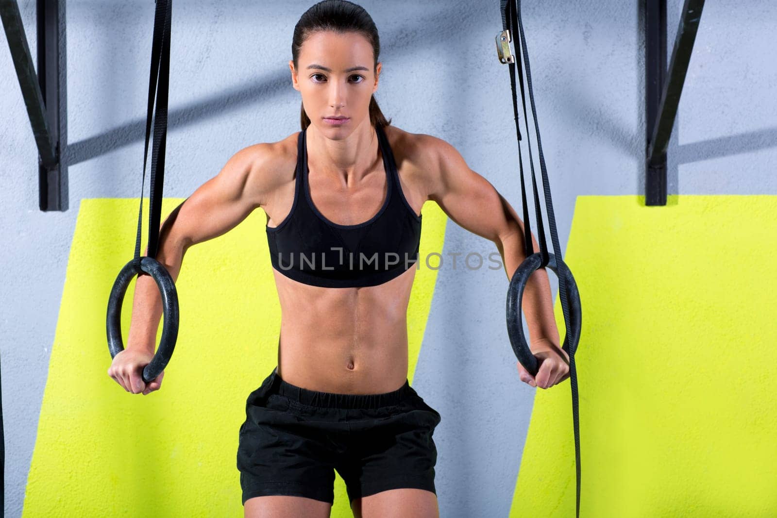Crossfit dip ring woman workout at gym dipping exercise