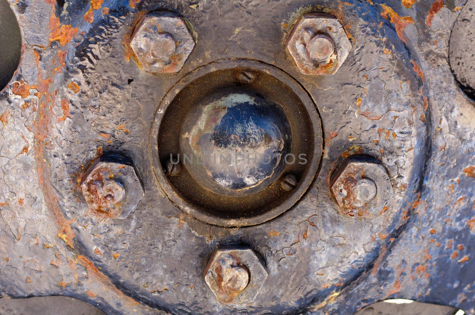 Rusty nuts at the surface of a wheel steel plate- closeup, macro