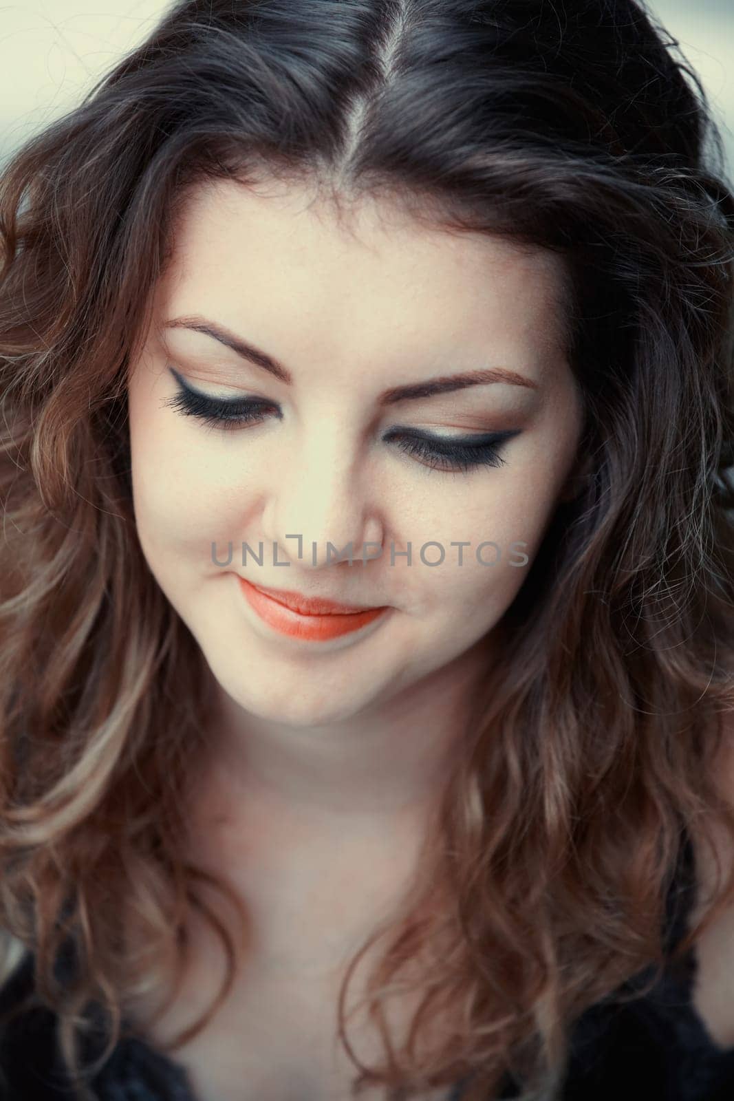 Portrait of a beautiful 20 year old woman looking down.
