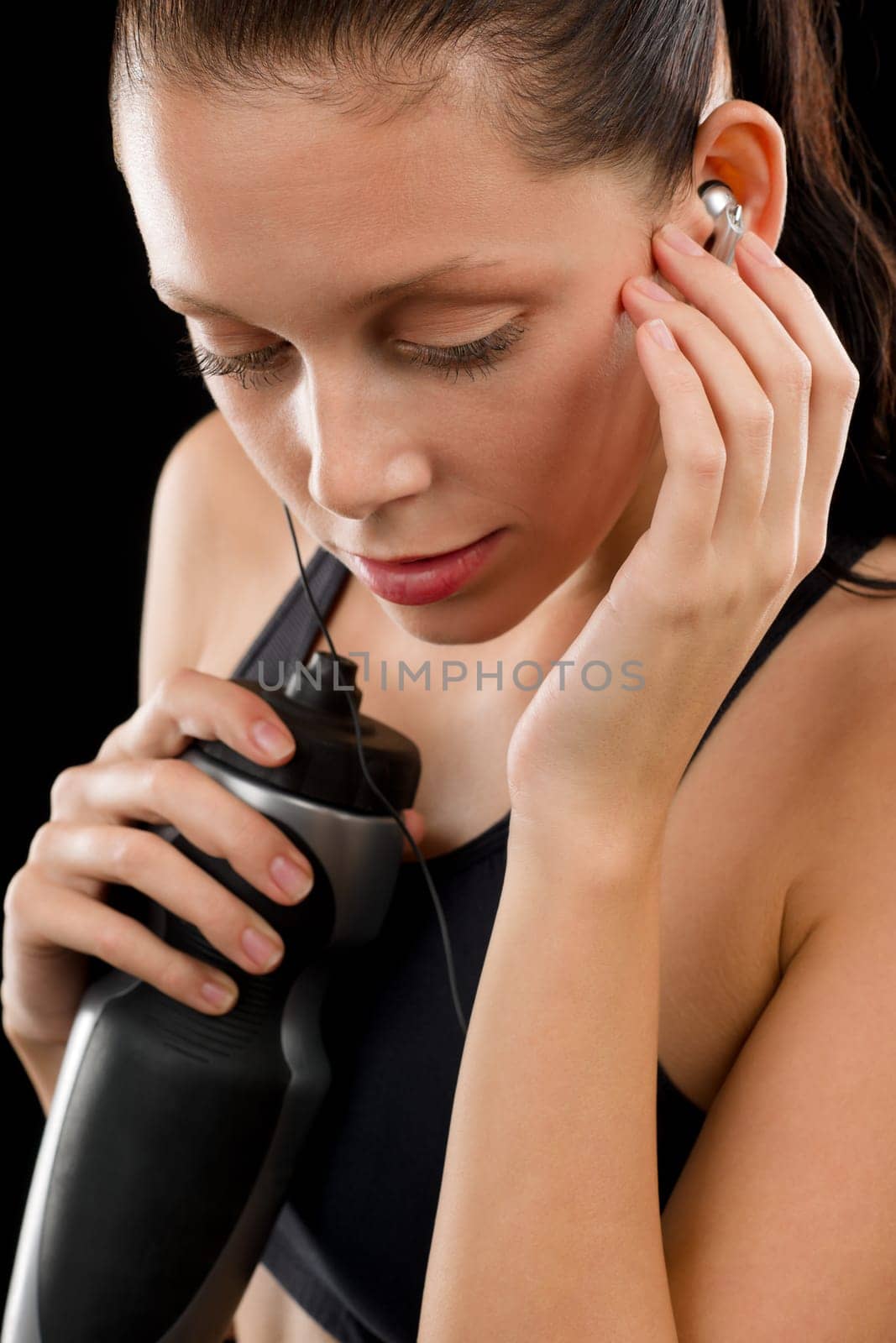 Close up of young beautiful sportive woman on black background