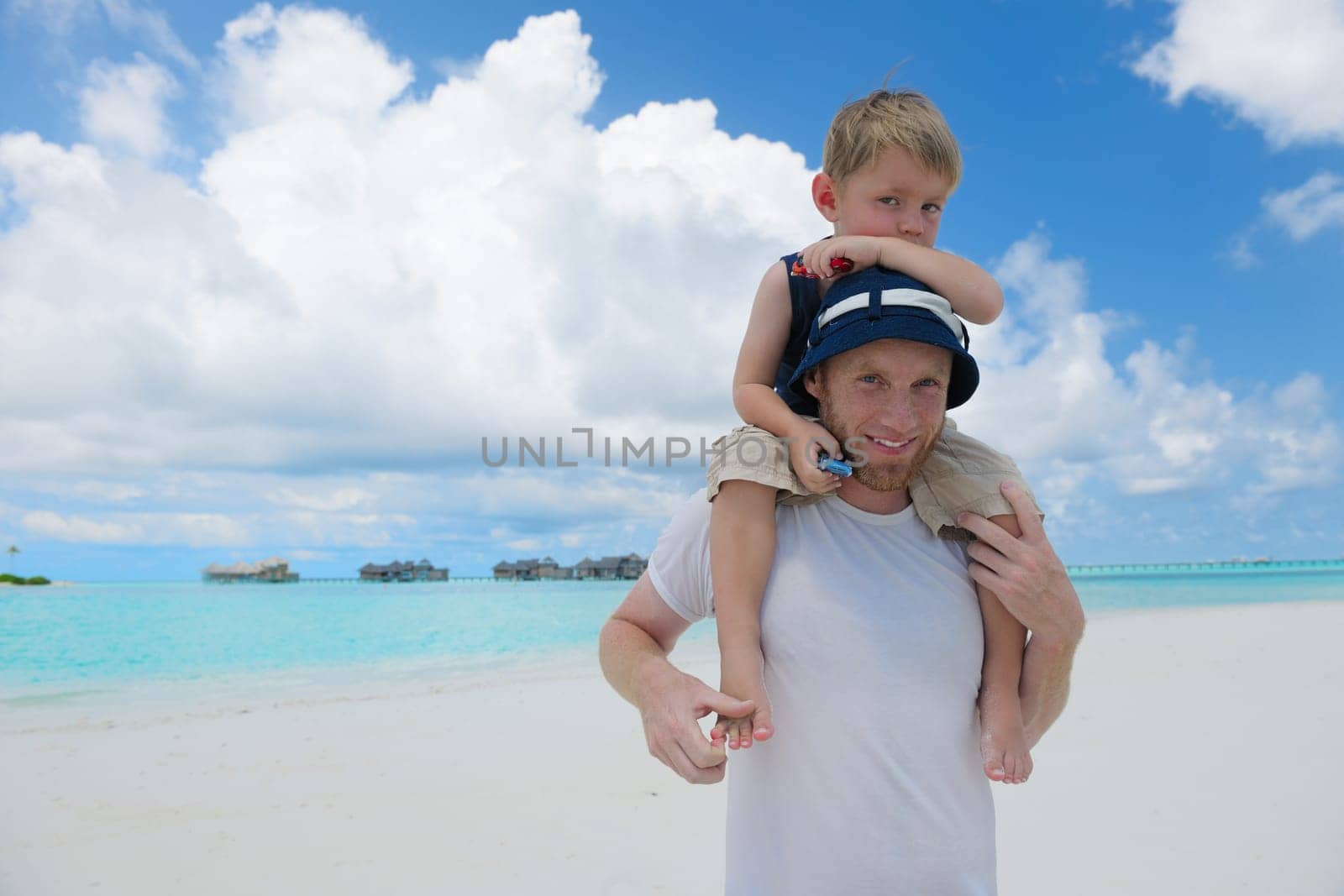 Portrait of a happy family on summer vacation  at beach