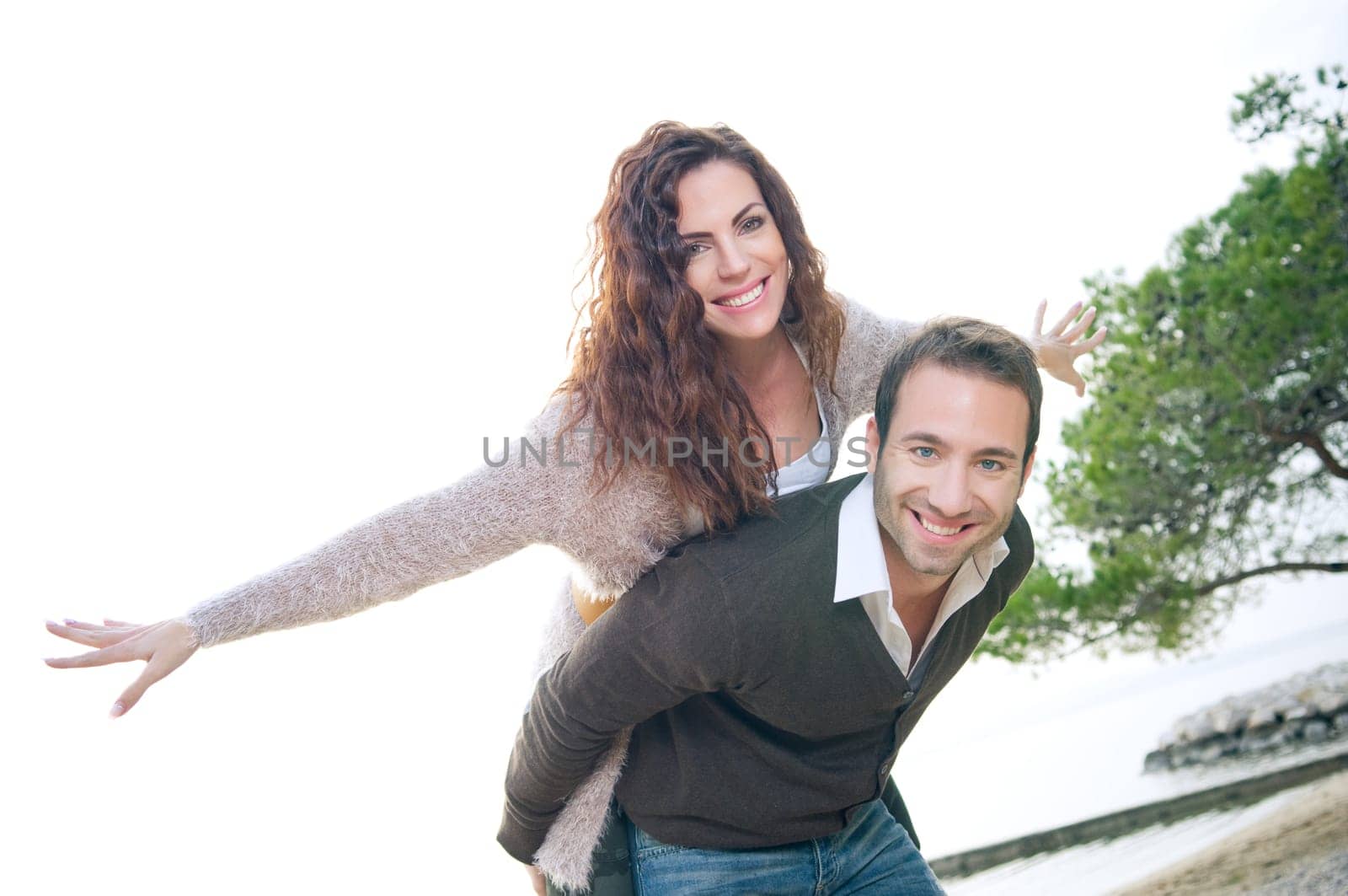 Portrait of a happy young couple having fun on the beach