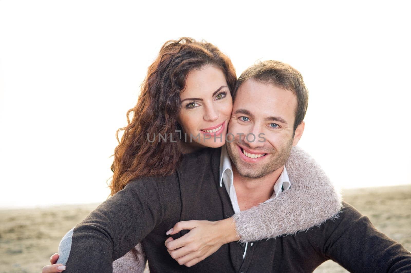 Beautiful happy young couple at the beach