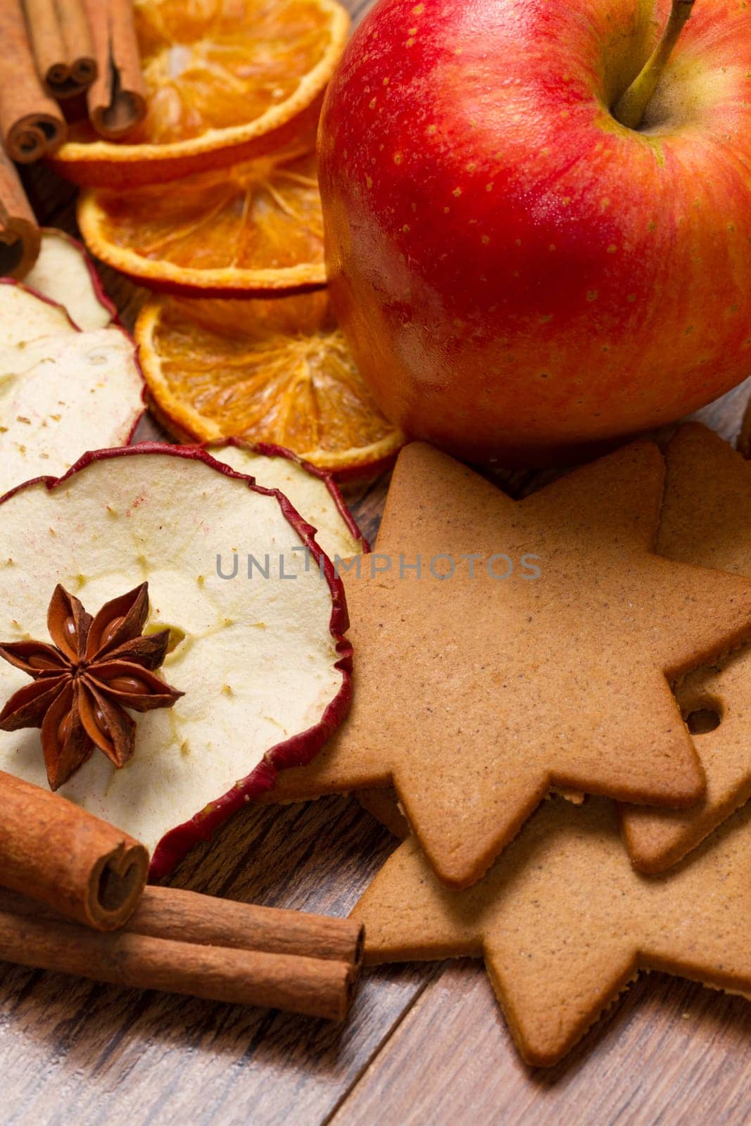 fresh apple with biscuit,cinnamon and fruit dried on wooden table