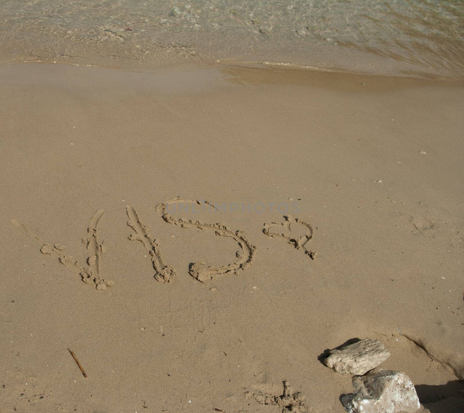 Vis word in the sand at the beach