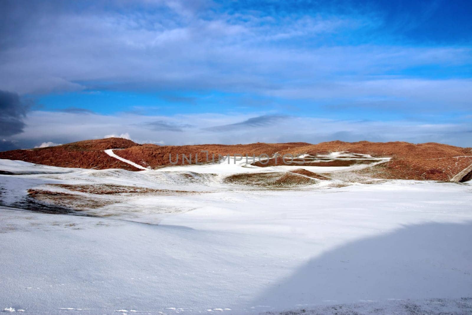 a snow covered with stormy sky links golf course in ireland in winter