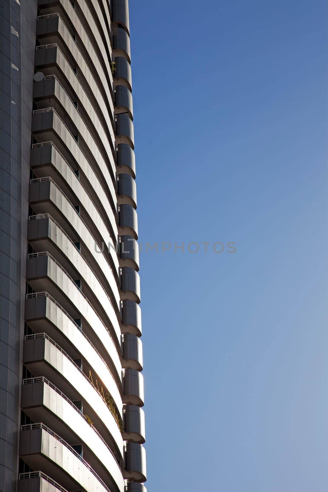 Perspective and underside angle view of modern glass building skyscrapers over blue sky