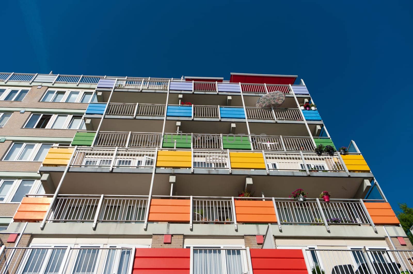 exterior of a modern retirement apartment building with colorful balconies
