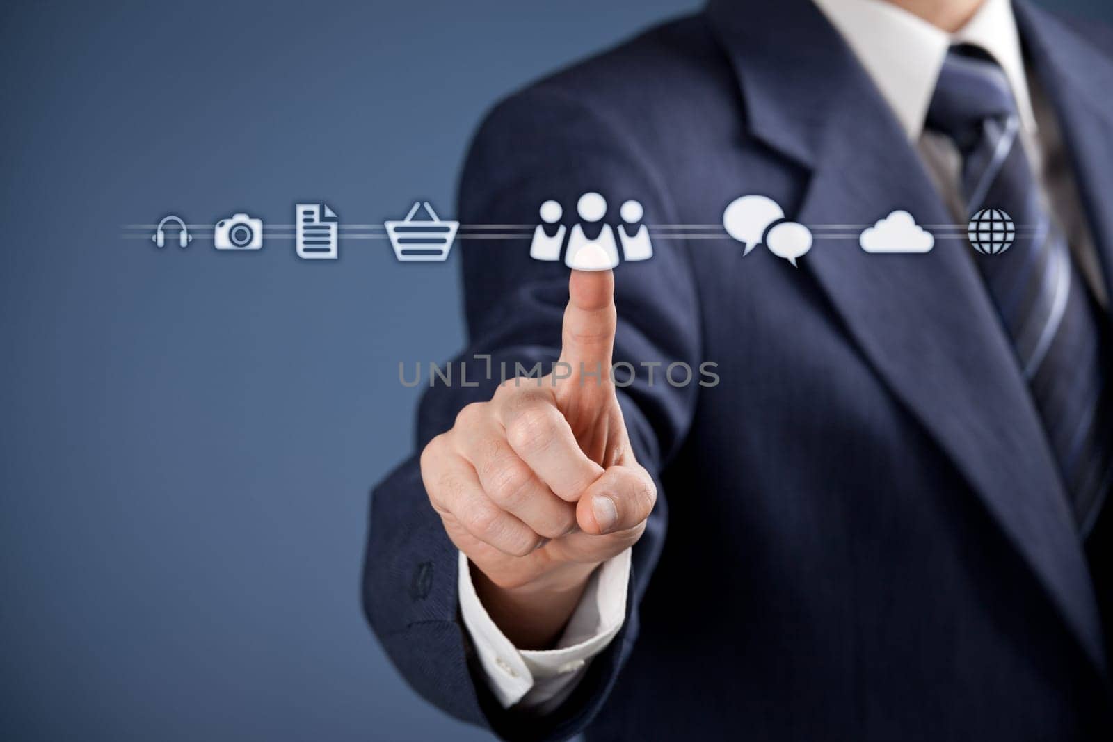 Social media concept - businessman click on virtual icon representing social media. Horizontal composition, blue background, selective focused on hand.