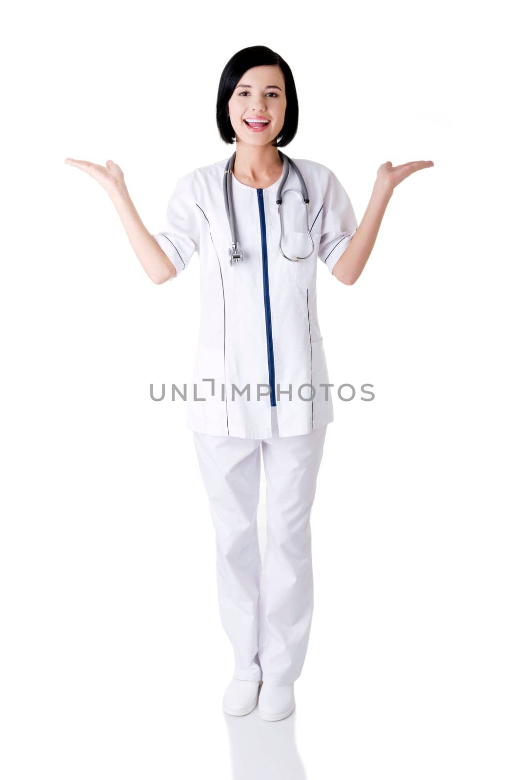 Young medical doctor woman presenting and showing copy space for product or text.