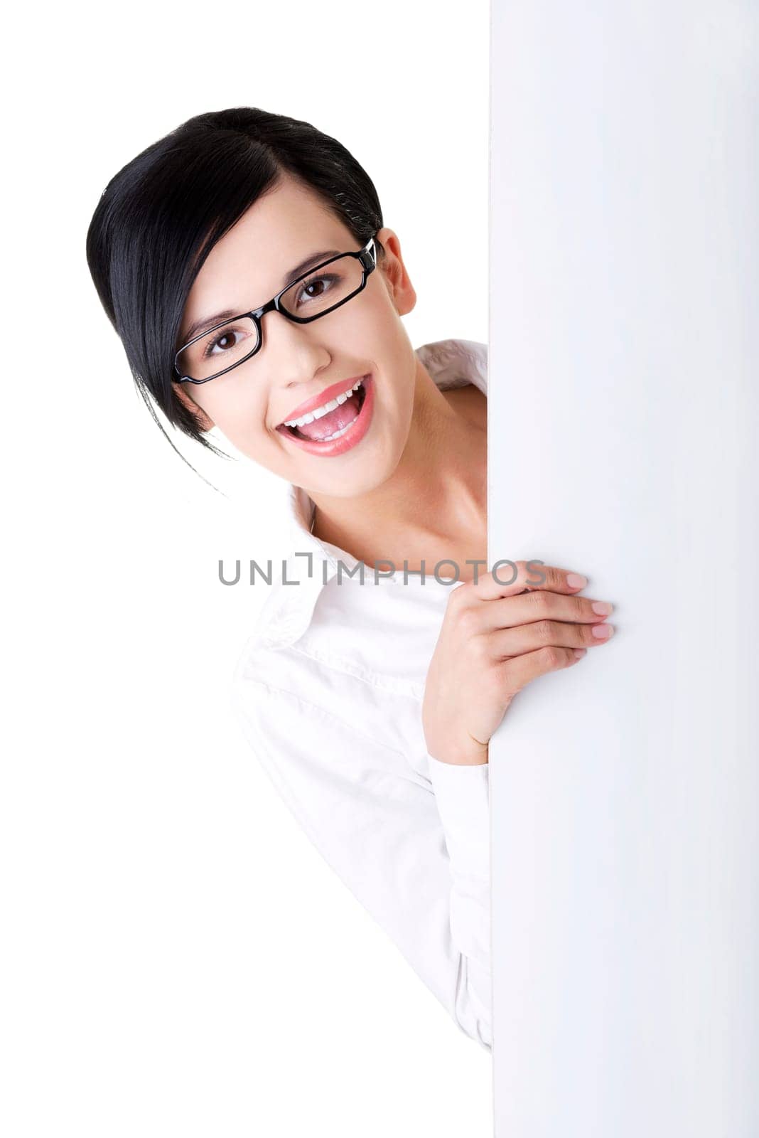 Smiling young business woman showing blank signboard, over white background isolated