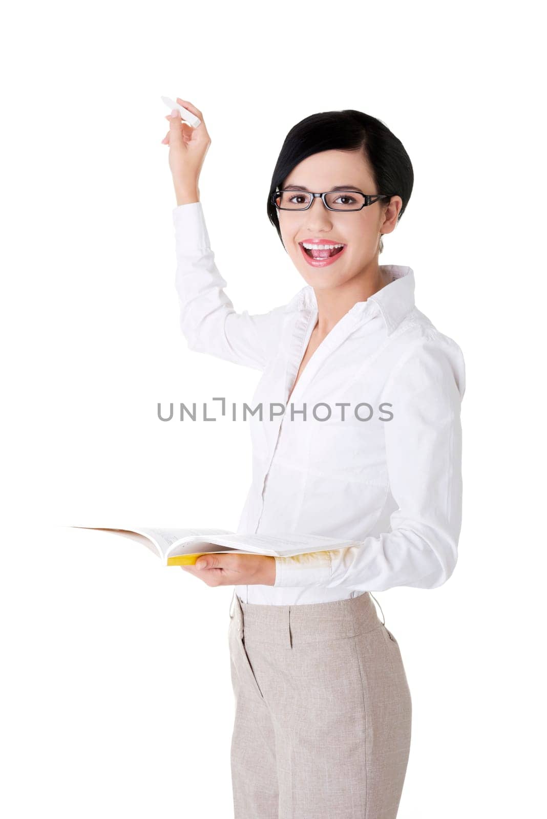 Teacher with book and chalk in hands presenting something on abstract chalkboard. Isolated on white