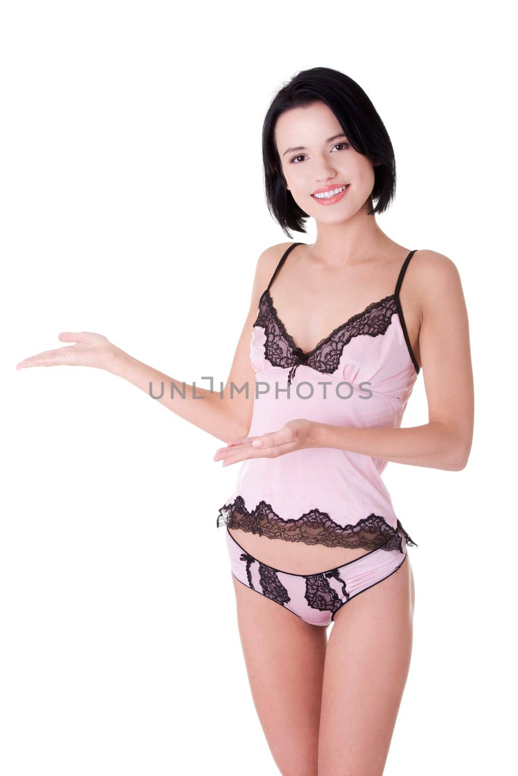 Beautiful slim woman in lingerie presenting copy space. Isolated on white background.