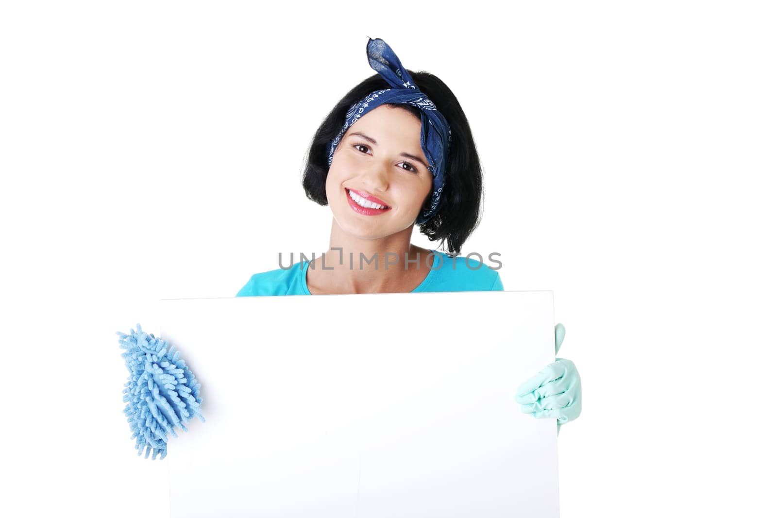 Smiling happy cleaning woman showing blank sign board.