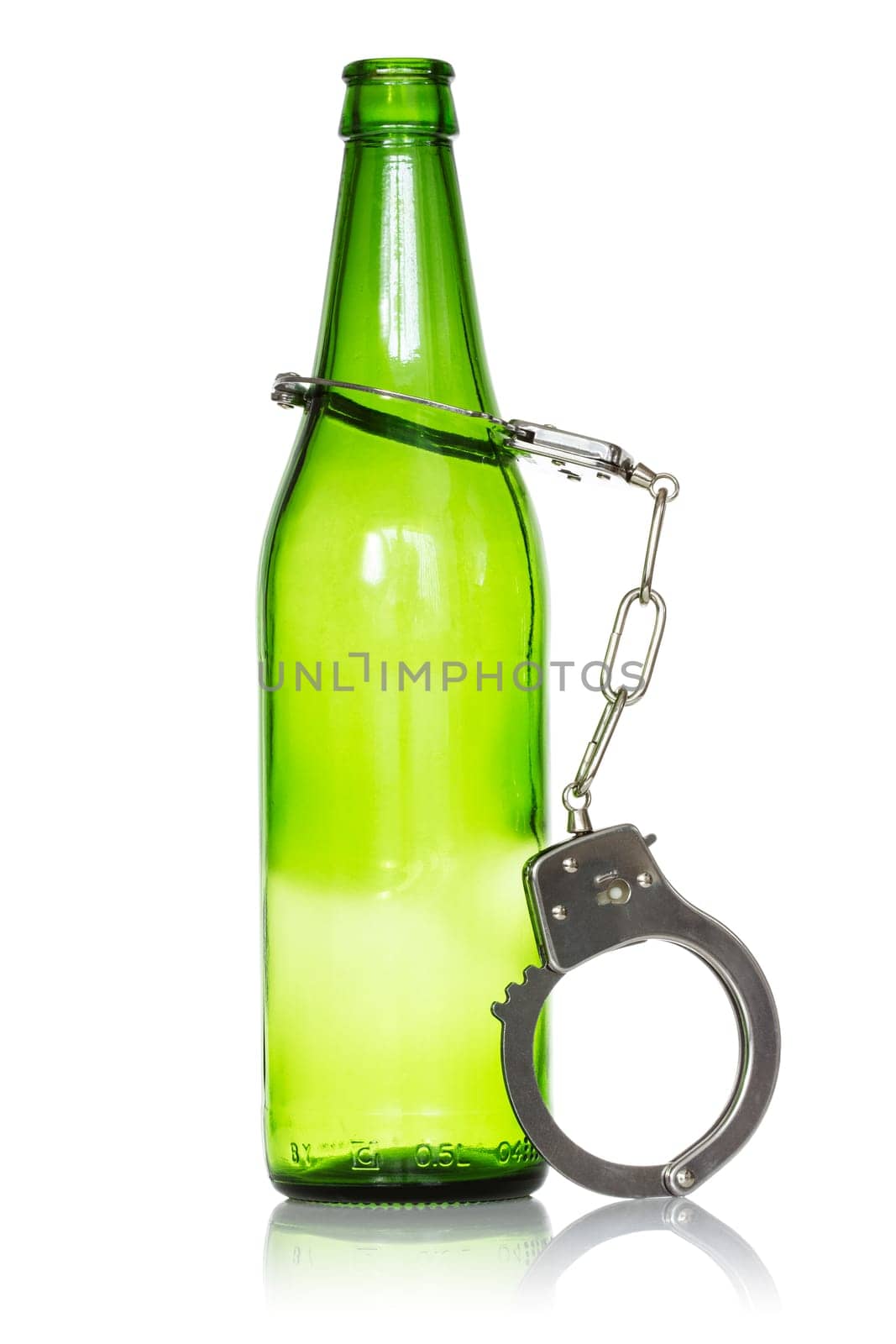 Alcoholism and drunk driving concept. Bottle and handcuffs over a white background