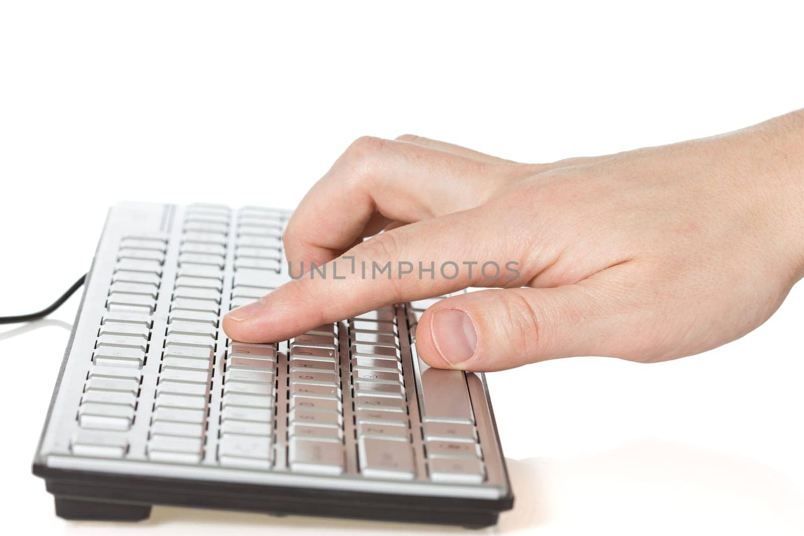 Hand typing on  computer keyboard over a white background