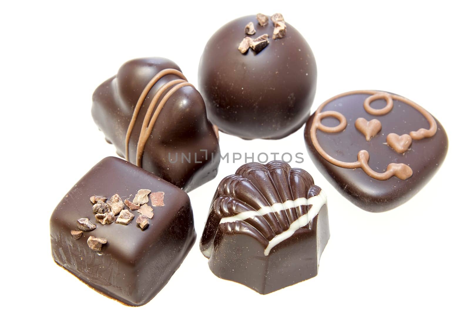 Dark Chocolate Assortment with Truffles Heart Swirls Nuts Isolated on White Background