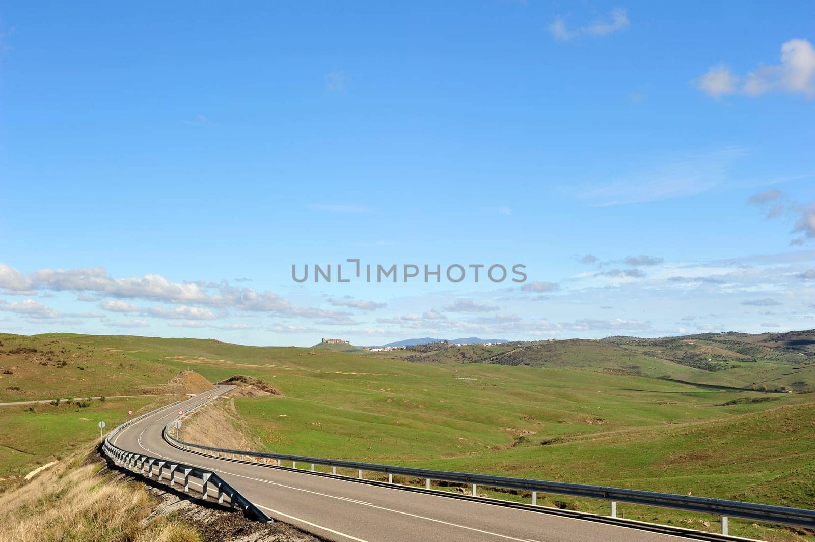Landscape in Extremadura with castle ruins on the horizon