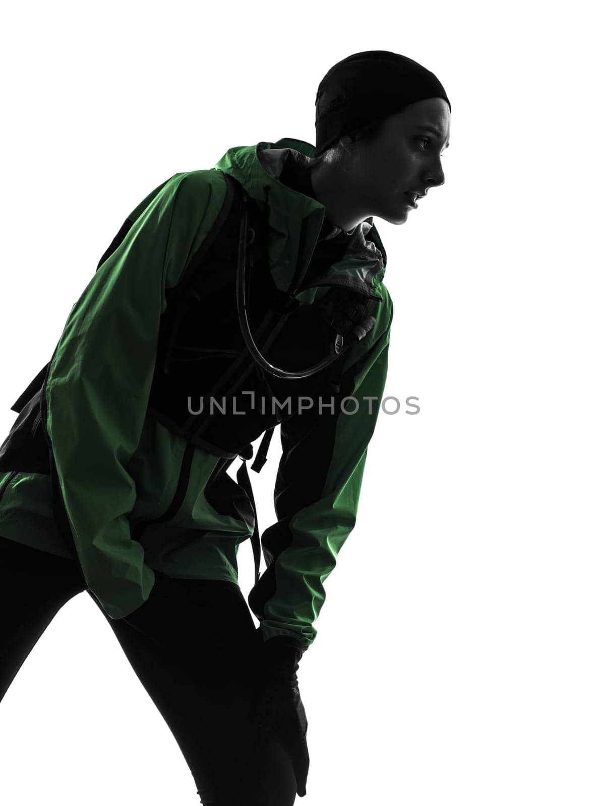 one causasian woman runner running trekking  in silhouette studio isolated on white background