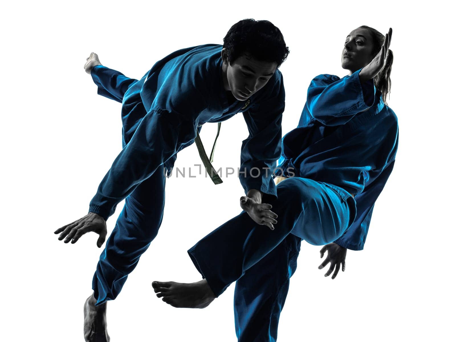 one  man woman couple exercising karate vietvodao martial arts in silhouette studio isolated on white background