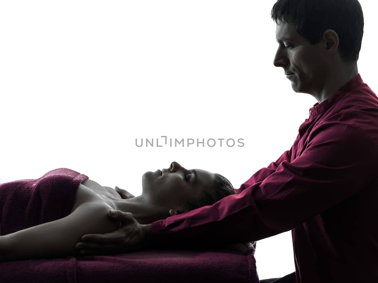 woman receiving shoulder massage  in silhouette studio on white background